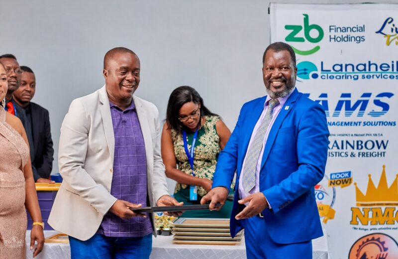 Benson Mukandiwa presenting a framed recognition at a corporate event
